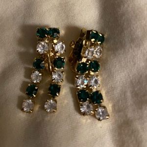 Clip on Trifari  earrings with green and clear rhinestones on gold.